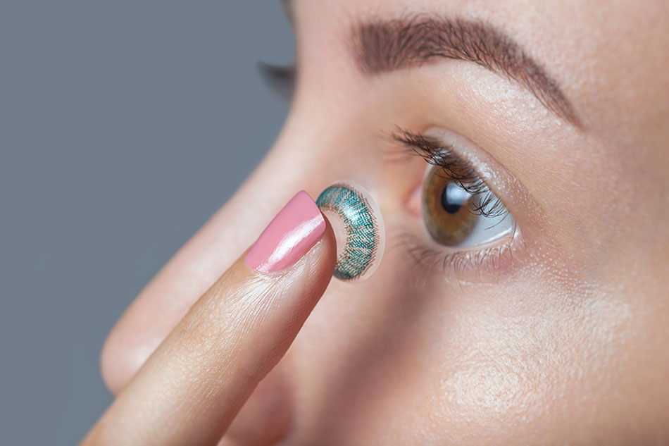 girl inserting coloured contacts